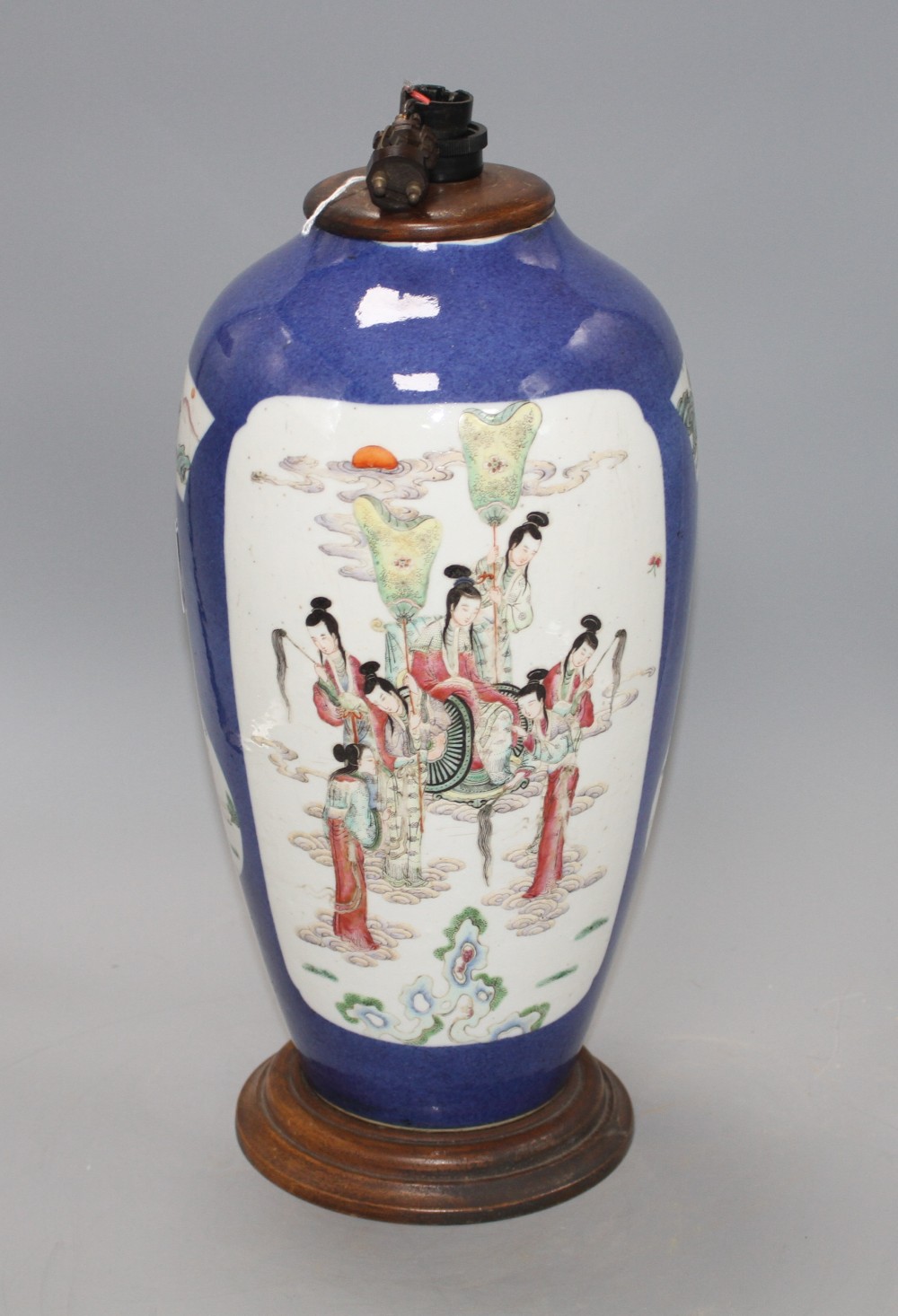 A 19th century Chinese famille rose baluster vase, now cut down and mounted as a table lamp, decorated with panels of immortals